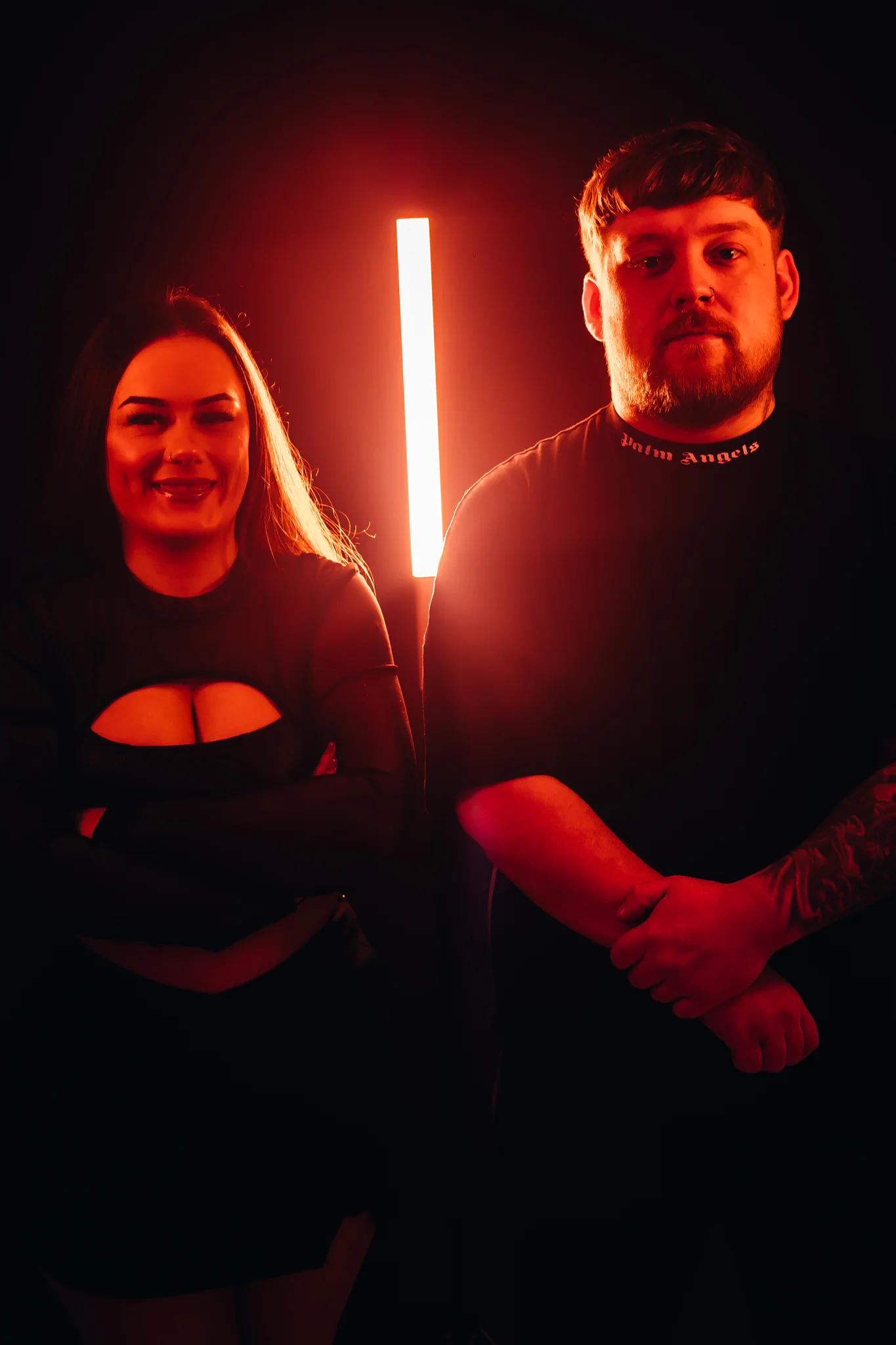 Jamie & Britney of Moodswing in a red-lit studio portrait
